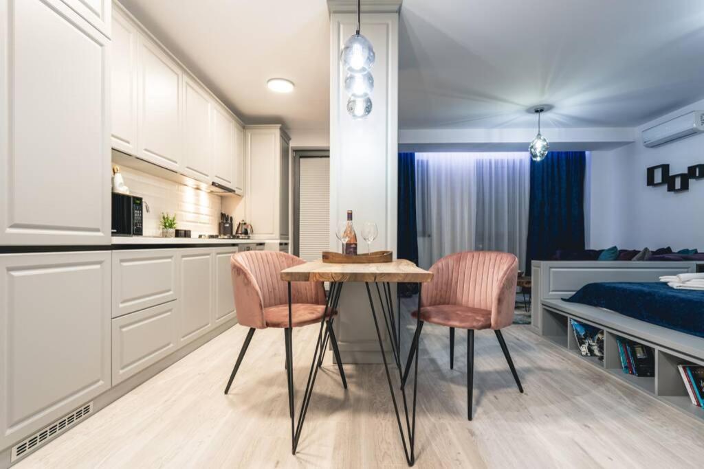 a kitchen and dining room with a table and chairs at Briana Luxury Panoramic View in Cluj-Napoca