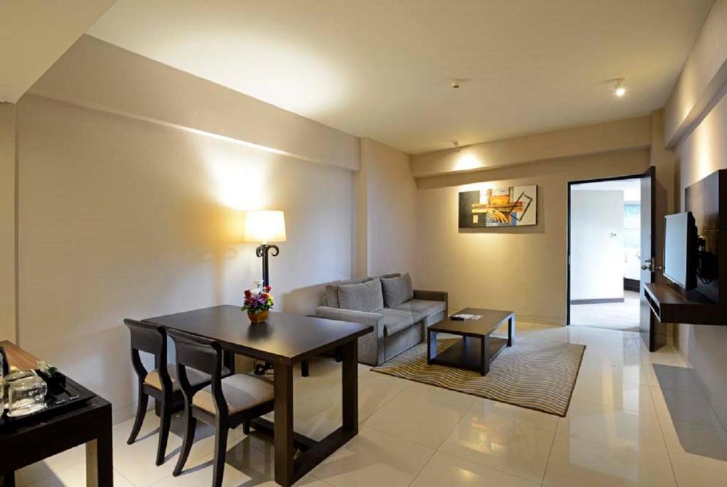 a living room with a table and a couch at Discovery Ancol in Jakarta