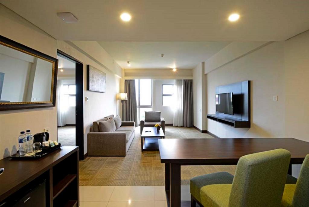 a living room with a couch and a table at Discovery Ancol in Jakarta