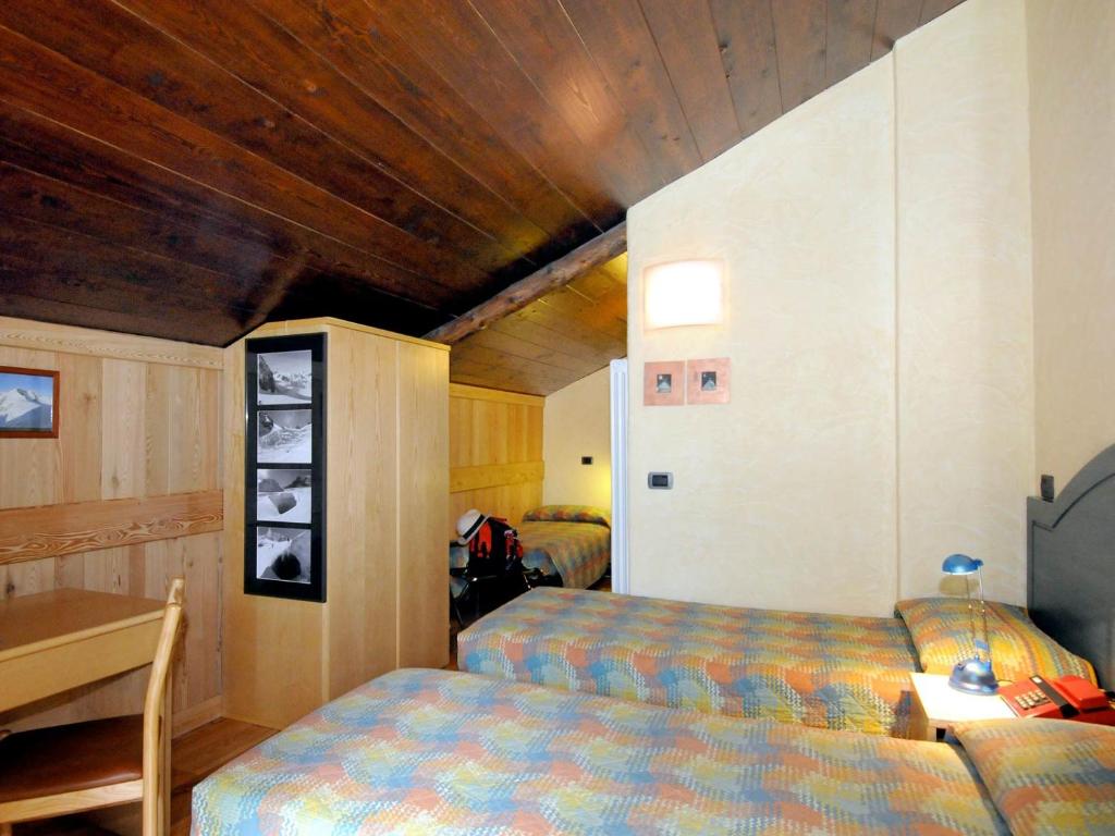 Postel nebo postele na pokoji v ubytování Hotel Aigle