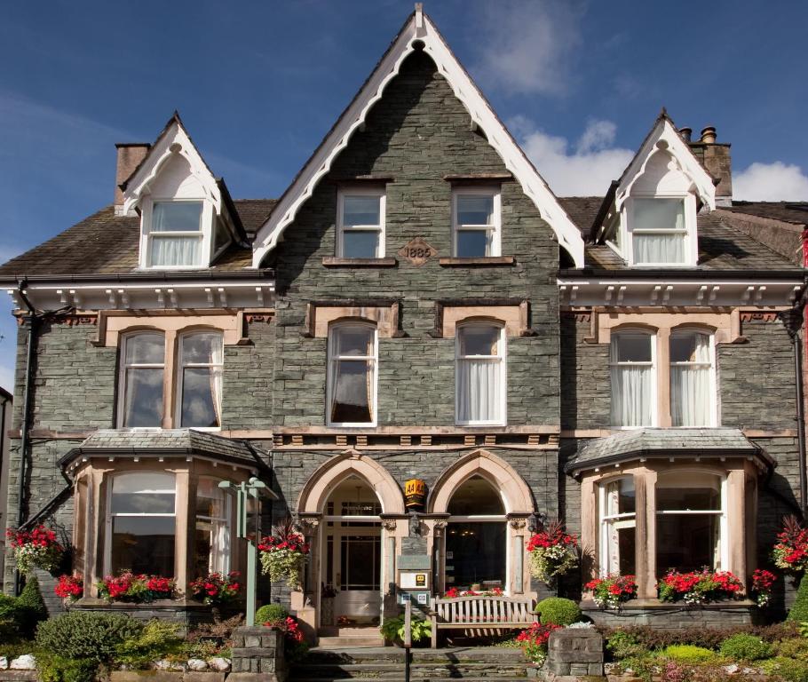 an old house with flowers in front of it at The Edwardene in Keswick