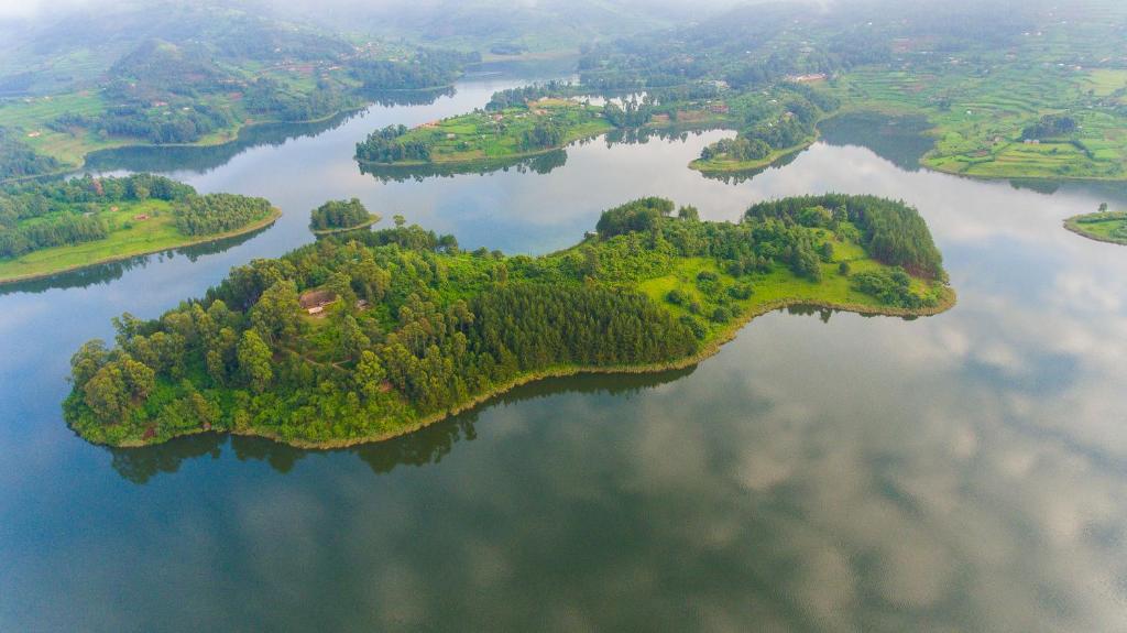an island in the middle of a body of water at Lake Bunyonyi Eco Resort in Chabahinga