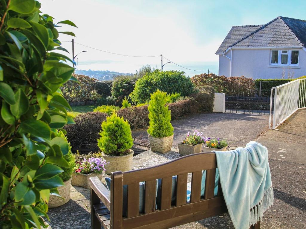 a bench with a towel on it in a garden at Garnedd Lwyd in Harlech