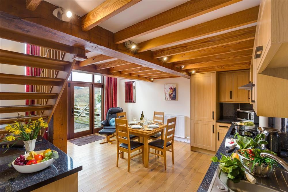 a kitchen and dining room with a table and chairs at Nest Barn in Keswick