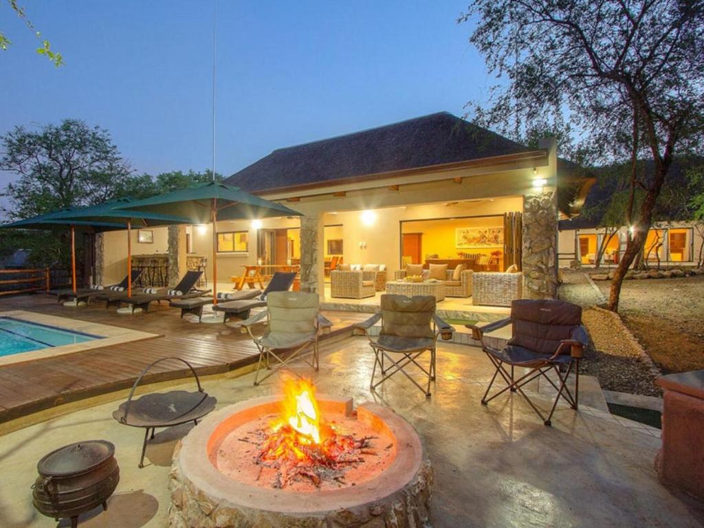 a fire pit in front of a house at The Den at Kruger 3479 in Marloth Park