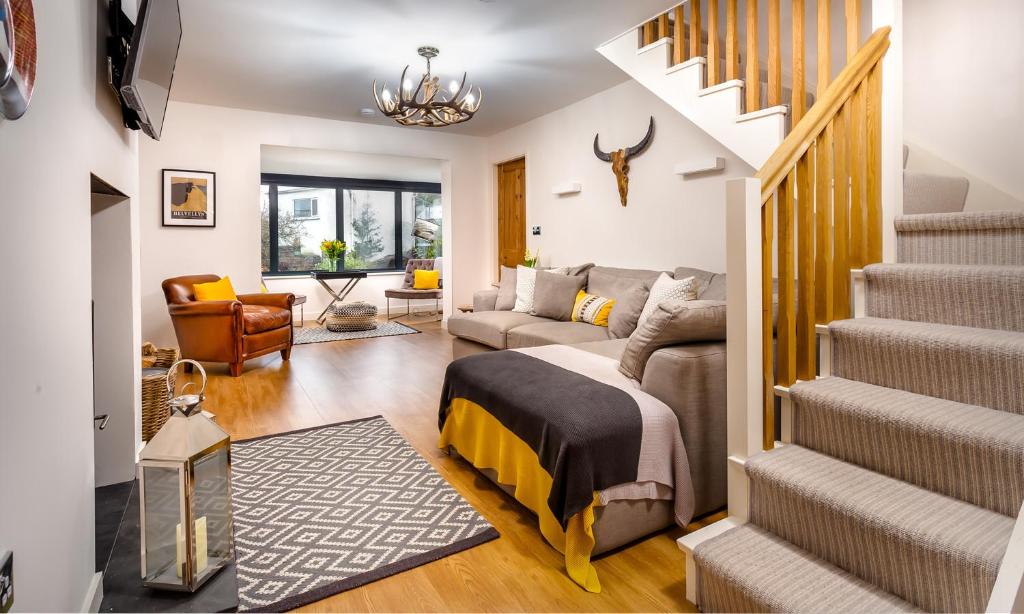 a living room with a bed and a staircase at Foxrock in Windermere