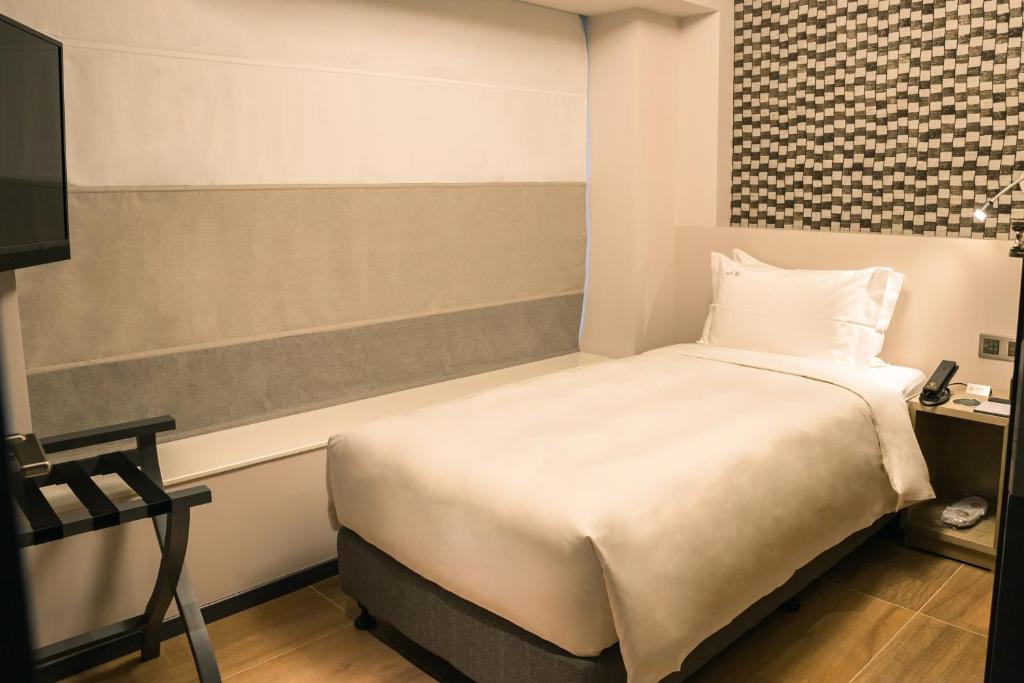Postel nebo postele na pokoji v ubytování City Inn Macau