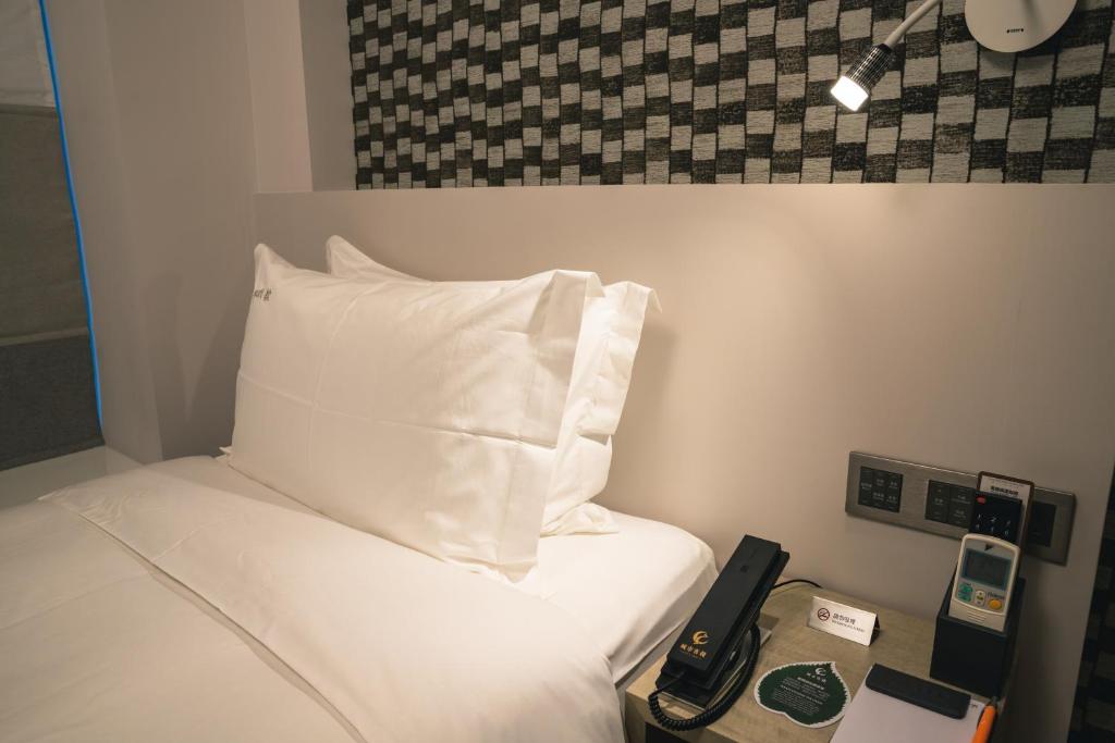 Postel nebo postele na pokoji v ubytování City Inn Macau