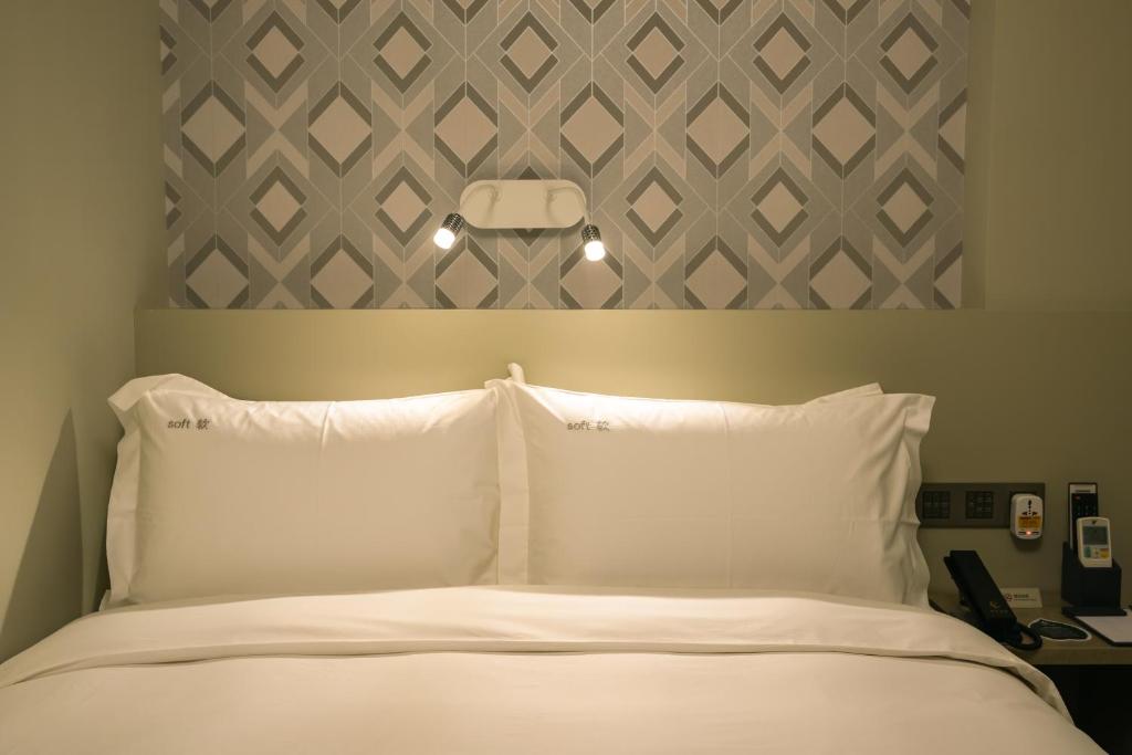 Postel nebo postele na pokoji v ubytování City Inn Macau
