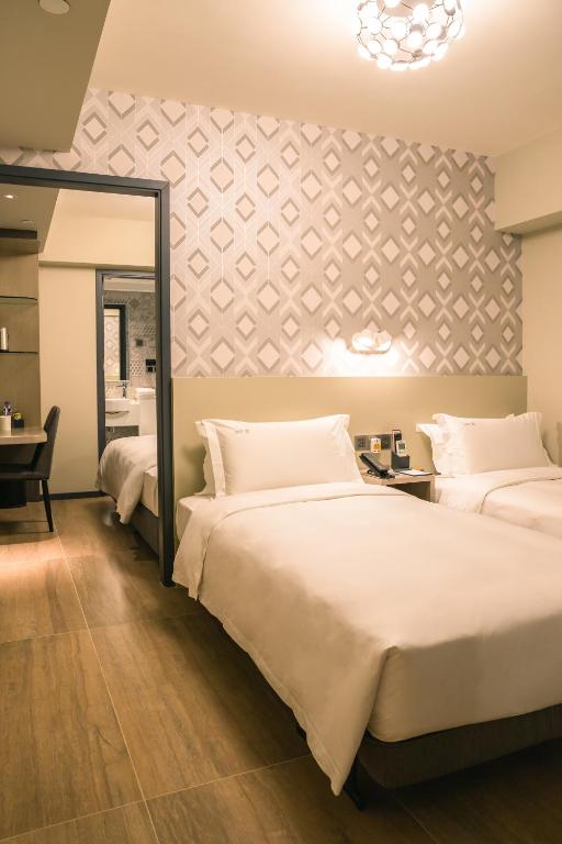 Postel nebo postele na pokoji v ubytování City Inn Macau