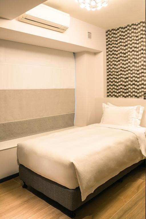 Postel nebo postele na pokoji v ubytování City Inn Macau