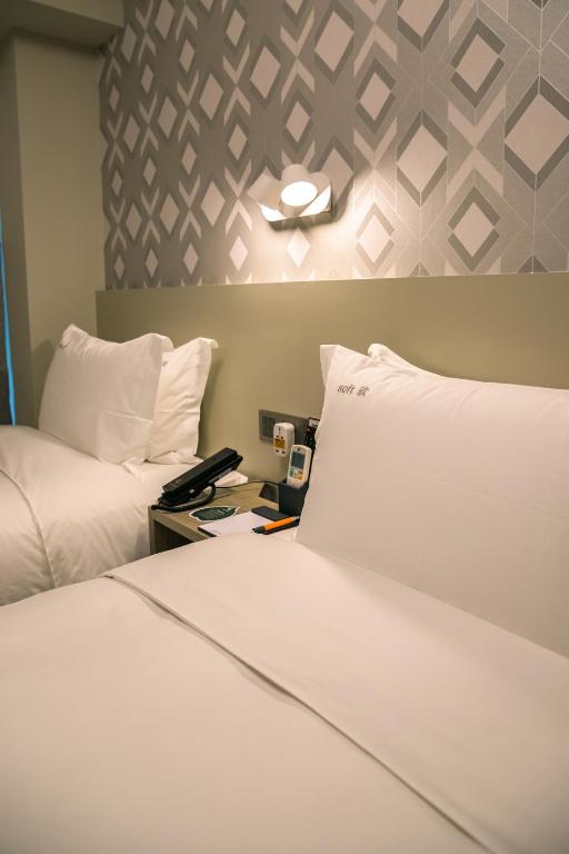 Postel nebo postele na pokoji v ubytování City Inn Macau