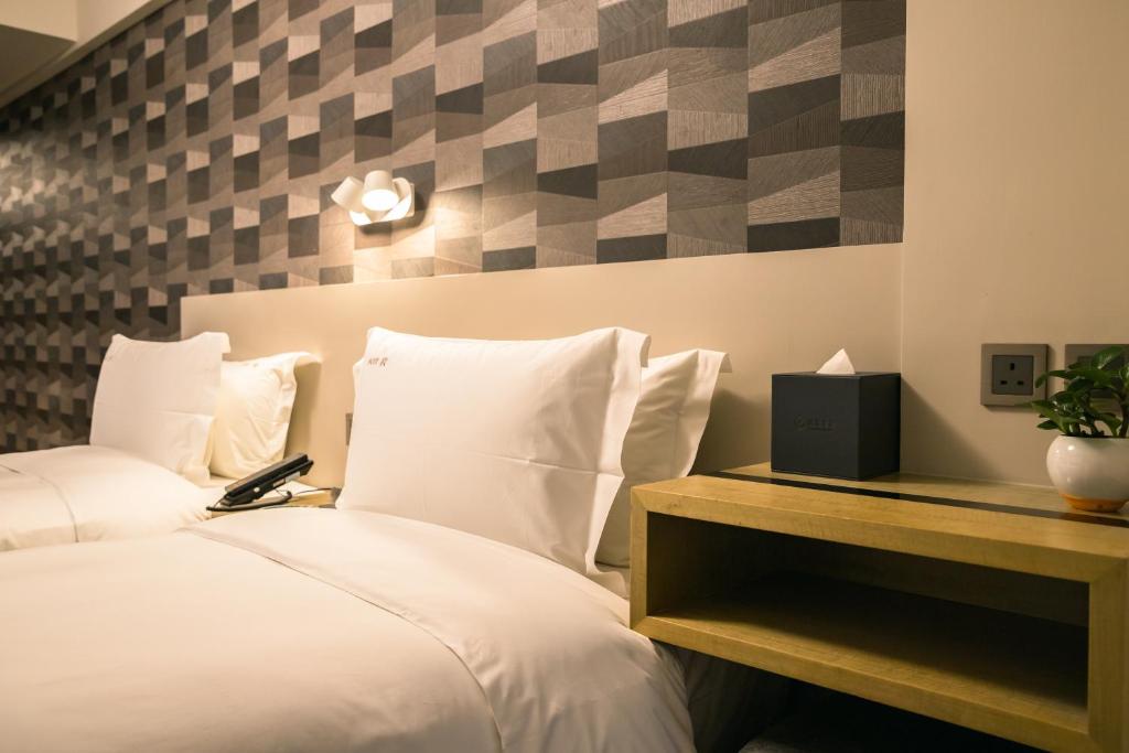 Postel nebo postele na pokoji v ubytování City Inn Macau
