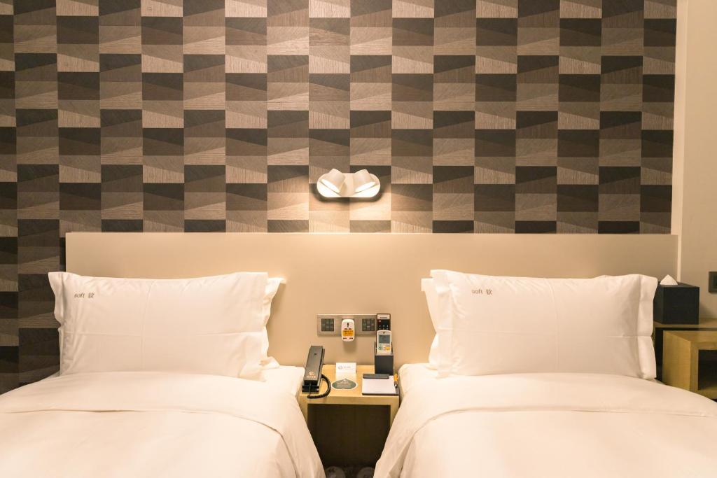 Postel nebo postele na pokoji v ubytování City Inn Macau