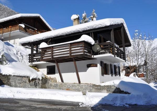 a house covered in snow with a roof at Melchior in Fiesch
