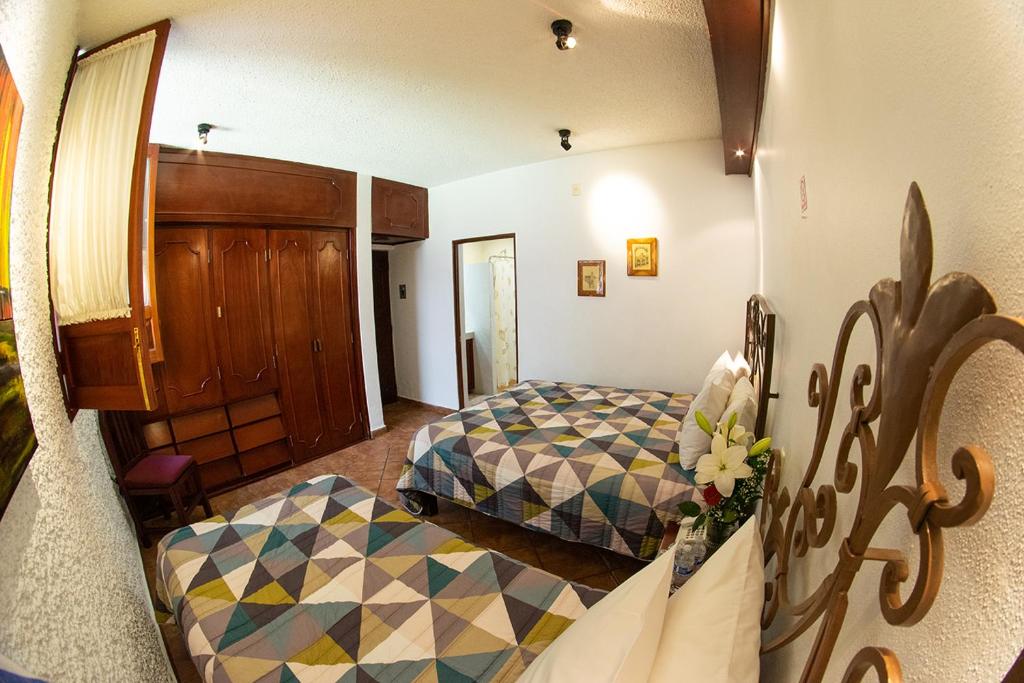 Postel nebo postele na pokoji v ubytování Hotel Mesón de los Remedios