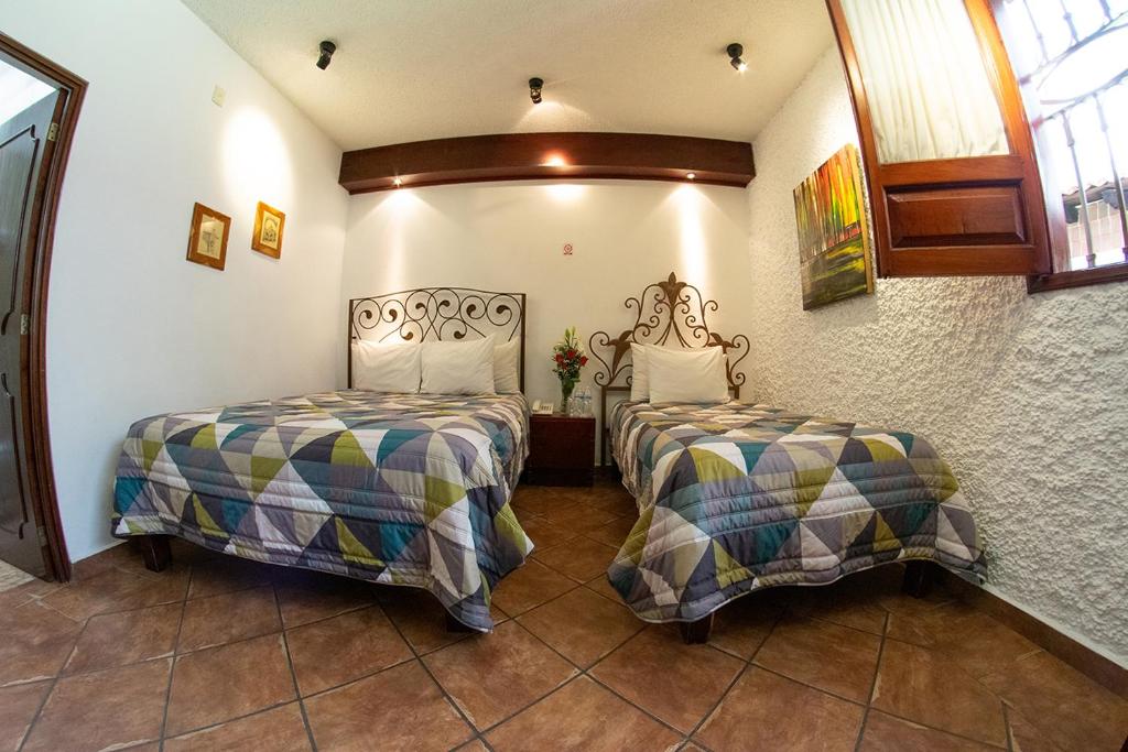 Postel nebo postele na pokoji v ubytování Hotel Mesón de los Remedios