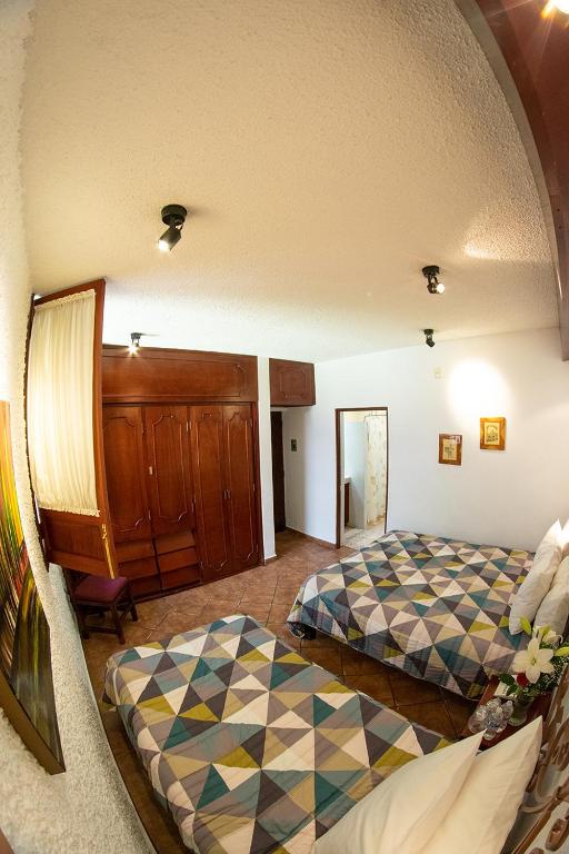 Postel nebo postele na pokoji v ubytování Hotel Mesón de los Remedios