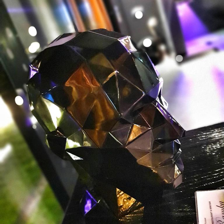 a faceted diamond trophy sitting on a table at Hotel Ramka & Restaurant & Wine Bar in Poznań