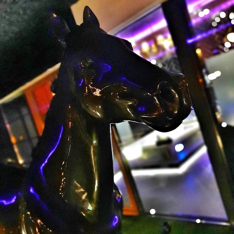 a glass horse statue sitting on top of a table at Hotel Ramka & Restaurant & Wine Bar in Poznań