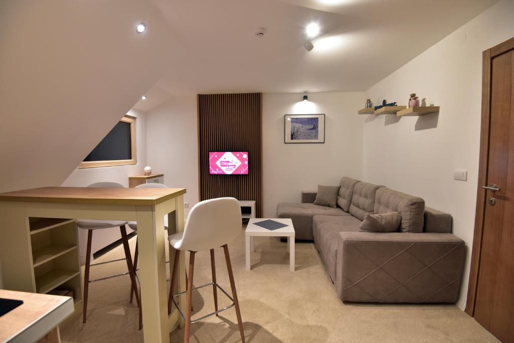 a living room with a couch and a table at Kopaonik konak Koznik in Kopaonik