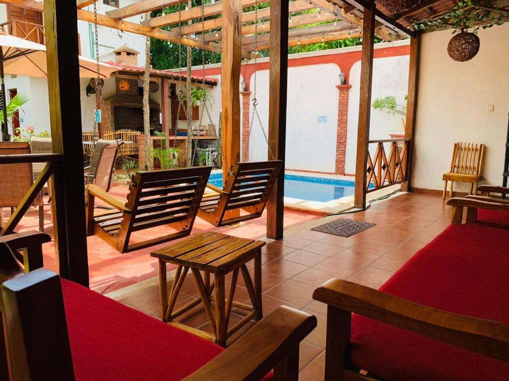 a room with chairs and a table and a patio at Casa de Descanso Lolha Bacalar in Bacalar