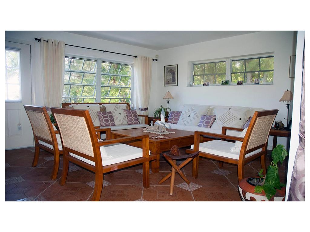 a living room with a couch and a table and chairs at Silver Point Villa in Freeport