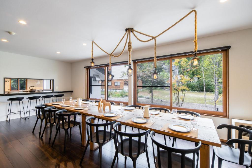 a large dining room with a long table and chairs at THE CASTLE by Hakuba Hotel Group in Hakuba