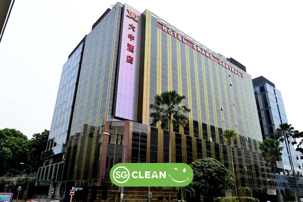 a large building with a sign in front of it at Hotel Grand Central in Singapore