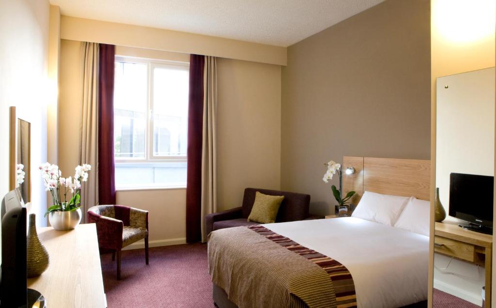 a hotel room with a bed and a window at Leonardo Hotel Aberdeen in Aberdeen