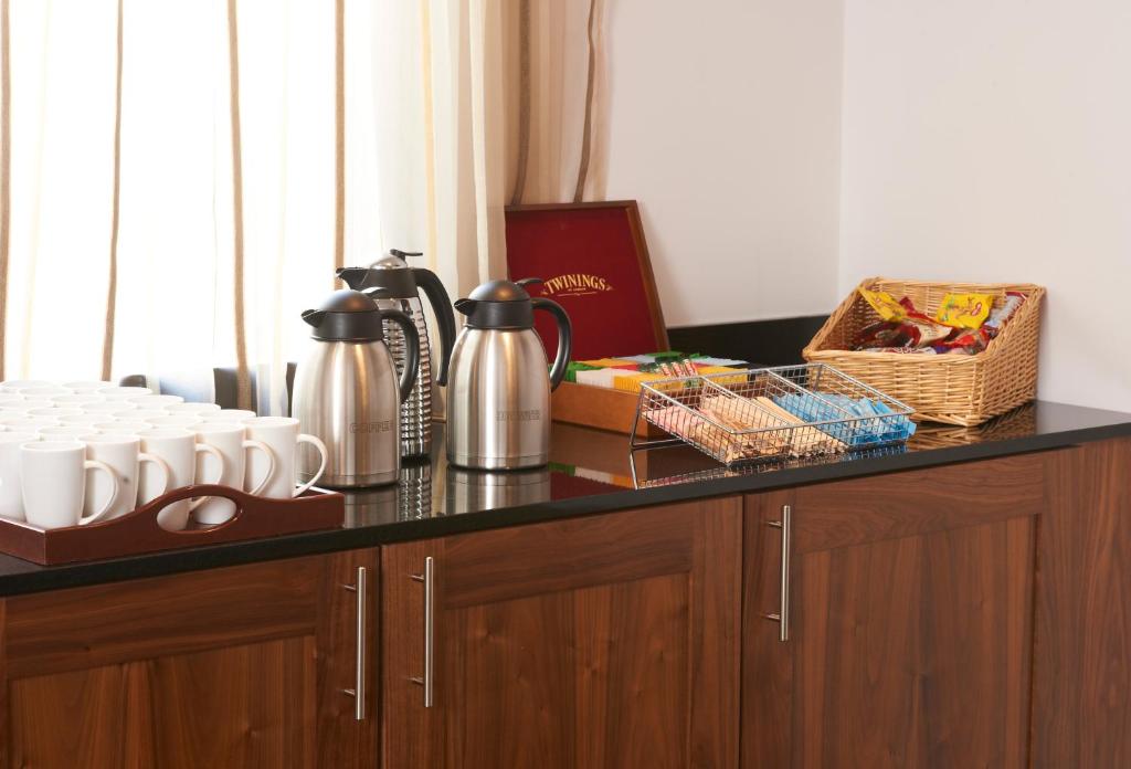 a counter top with cups and other items on it at Leonardo Hotel Aberdeen in Aberdeen