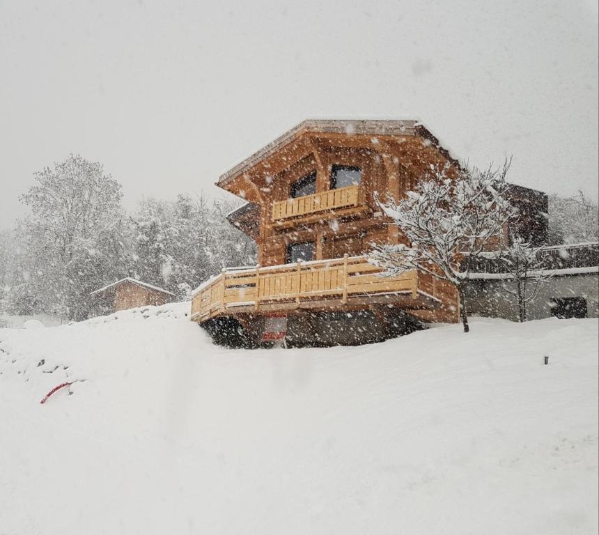 a log cabin in the snow with snow at le mazot in Combloux