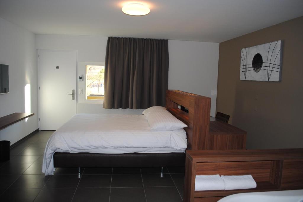 Postel nebo postele na pokoji v ubytování Hotel Du Soleil