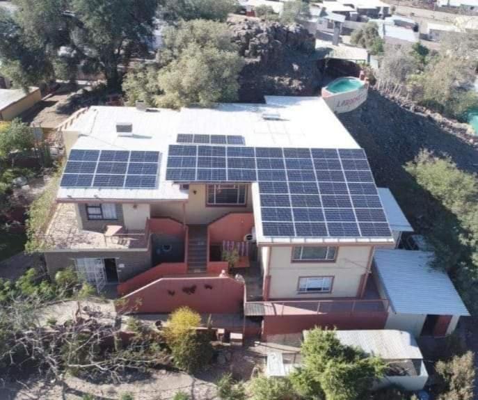 an aerial view of a house with solar panels on it at Larochelle Guesthouse in Keetmanshoop