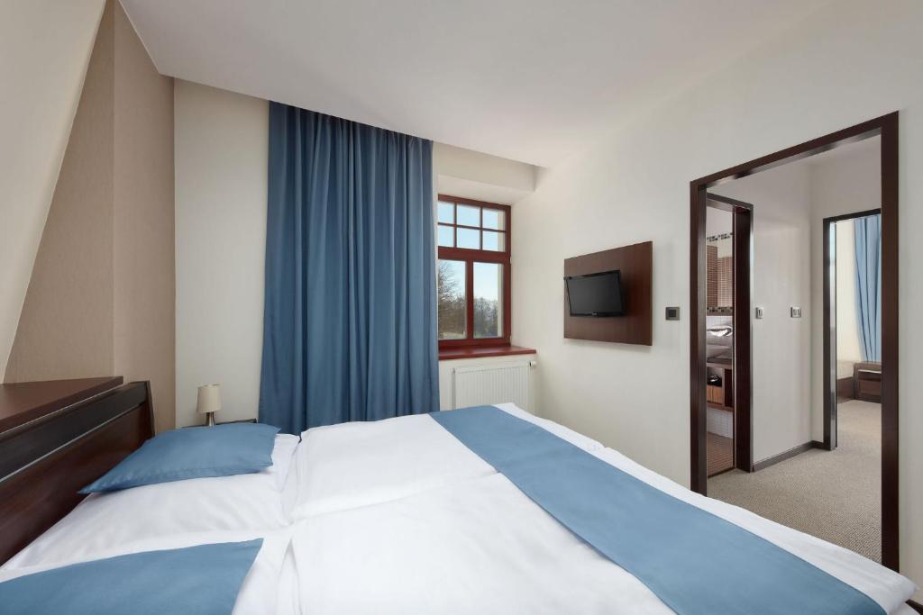 Postel nebo postele na pokoji v ubytování Hotel Slunný Dvůr
