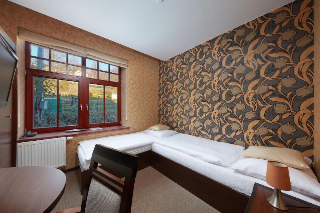 Postel nebo postele na pokoji v ubytování Hotel Slunný Dvůr
