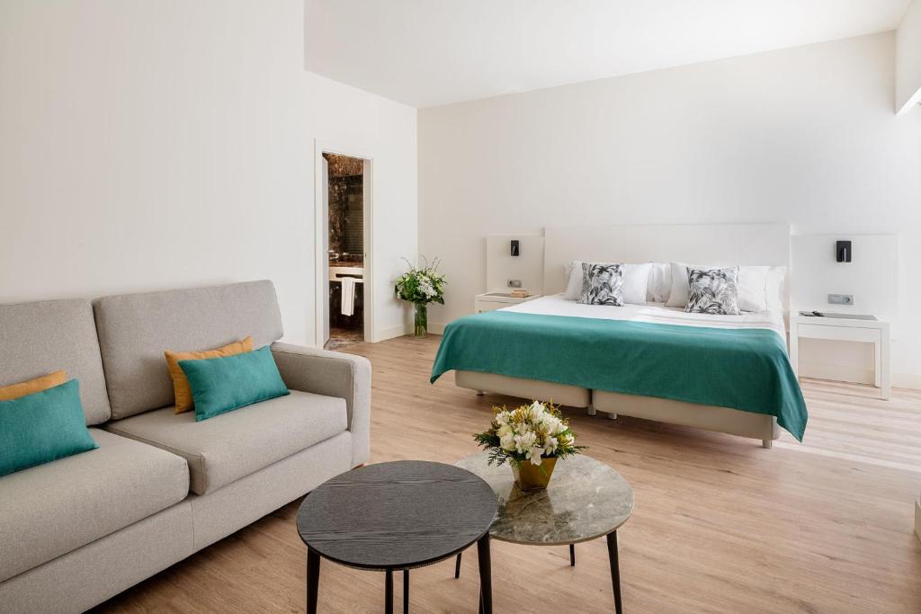 a living room with a bed and a couch at Arrecife Gran Hotel & Spa in Arrecife