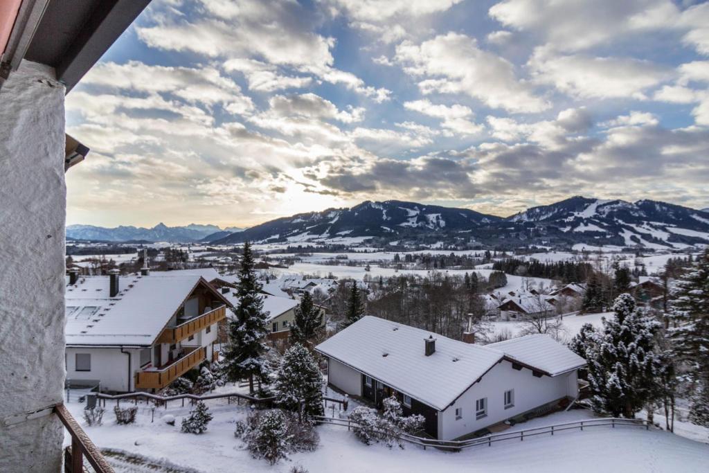 a view of a town in the snow with mountains at Appartement Förster in Oy-Mittelberg