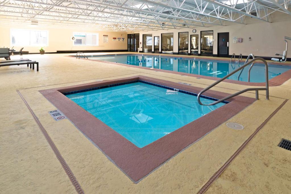a large swimming pool in a building at Days Inn by Wyndham Plattsburgh in Plattsburgh