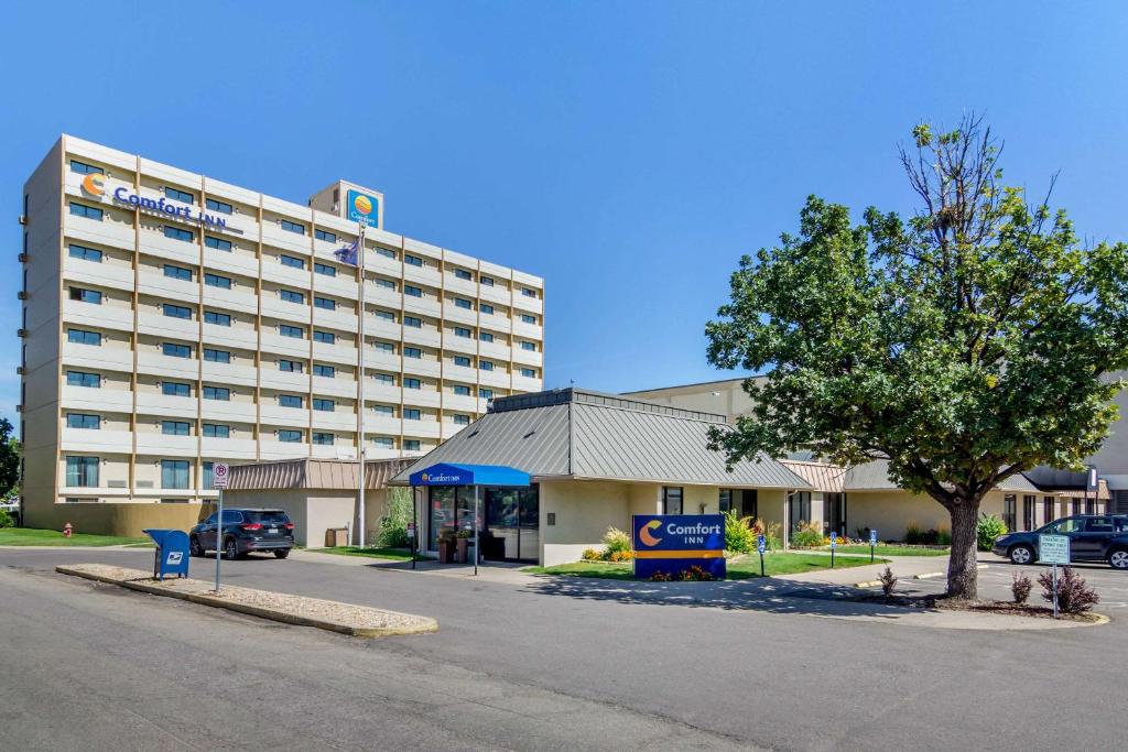 a large building with a parking lot in front of it at Comfort Inn Denver Central in Denver