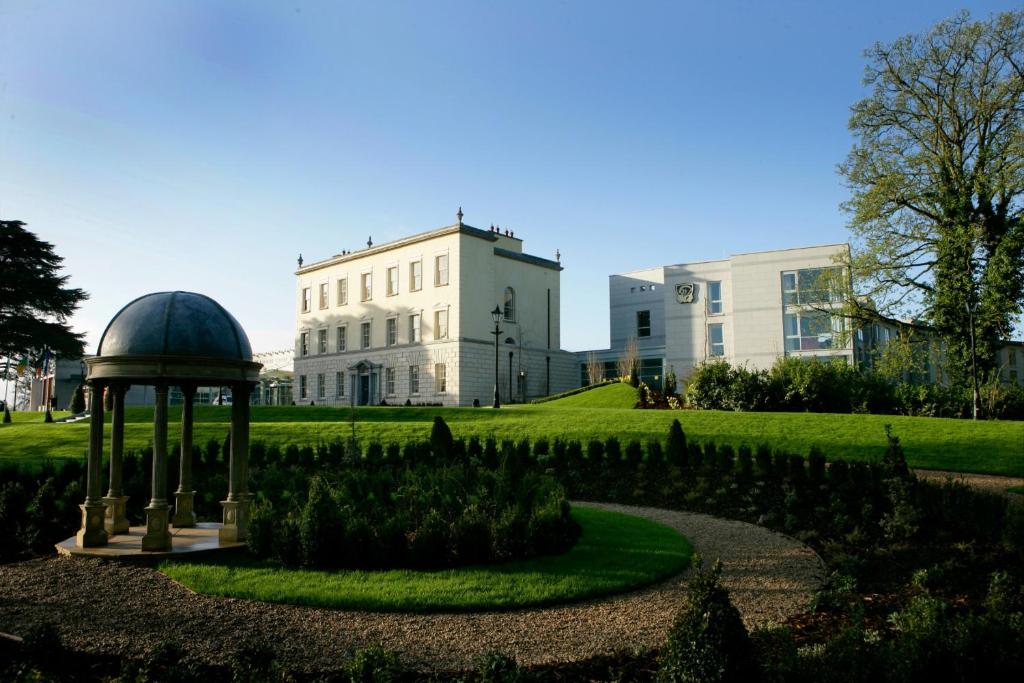 a building with a gazebo in front of a garden at Dunboyne Castle Hotel & Spa in Dunboyne