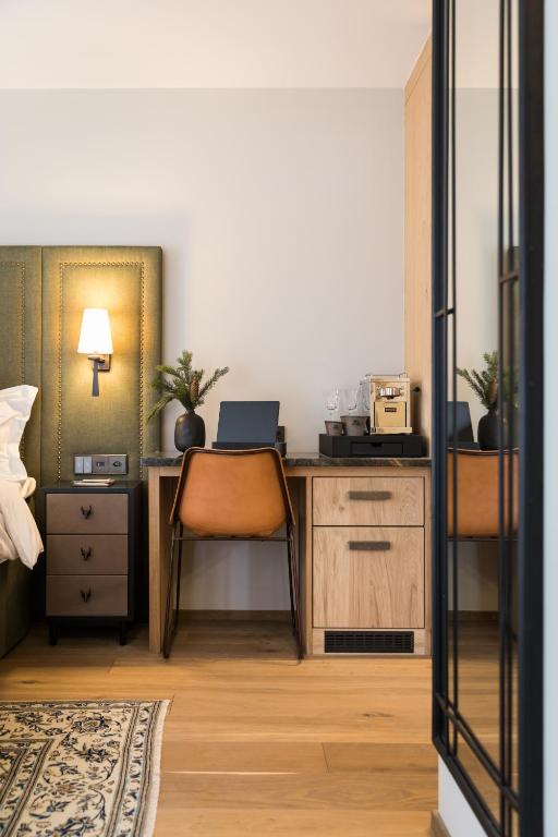 a bedroom with a desk with a laptop on it at Hôtel de Verbier SUP in Verbier