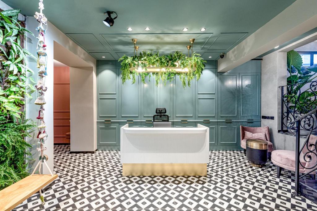 a bathroom with a bath tub and plants at Dizengoff Garden Hotel in Tel Aviv
