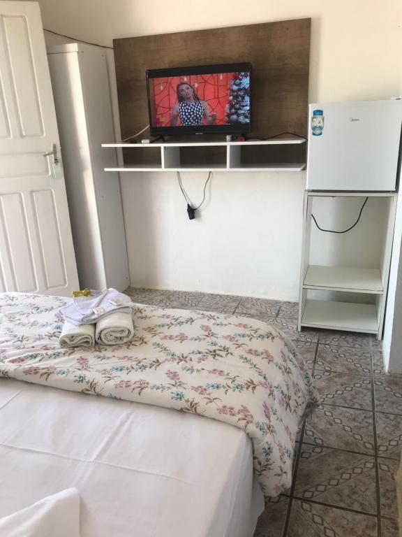 En tv och/eller ett underhållningssystem på Hotel Ilha Bella