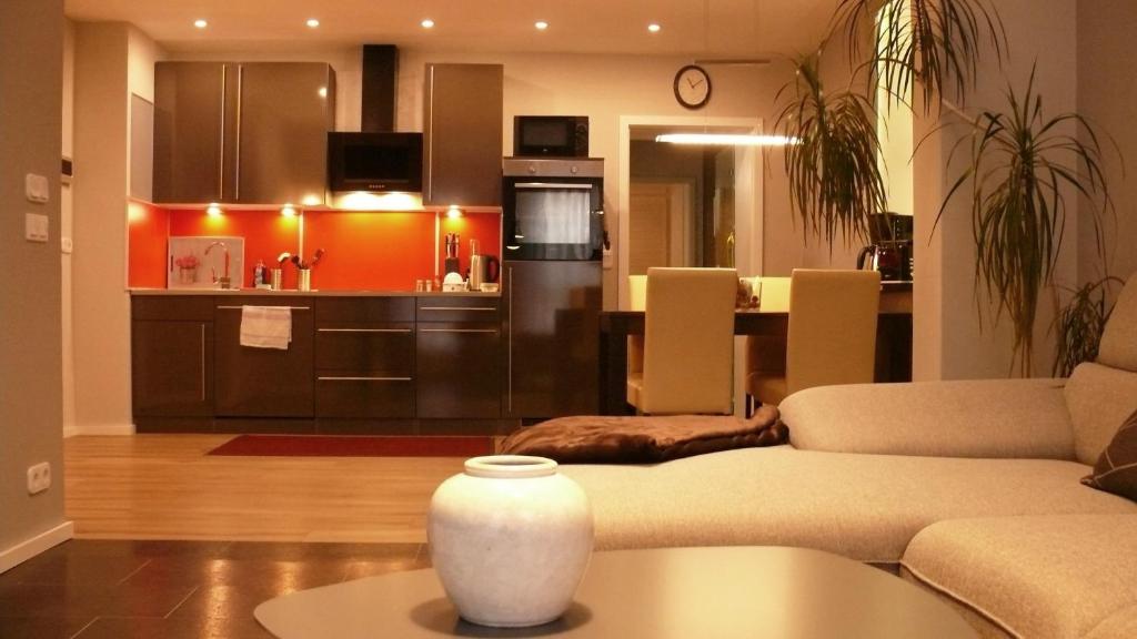 a living room with a couch and a kitchen at Ferienapartement Stuermer in Nordhausen