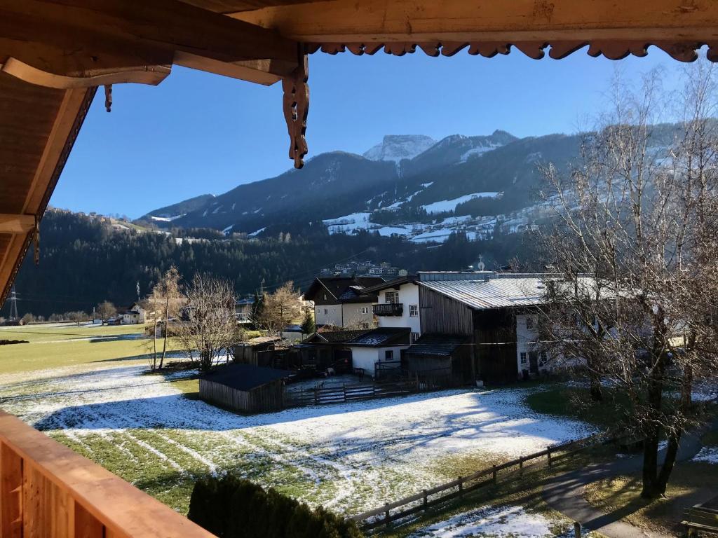a view from the porch of a house in the snow at Haus Garber in Zell am Ziller