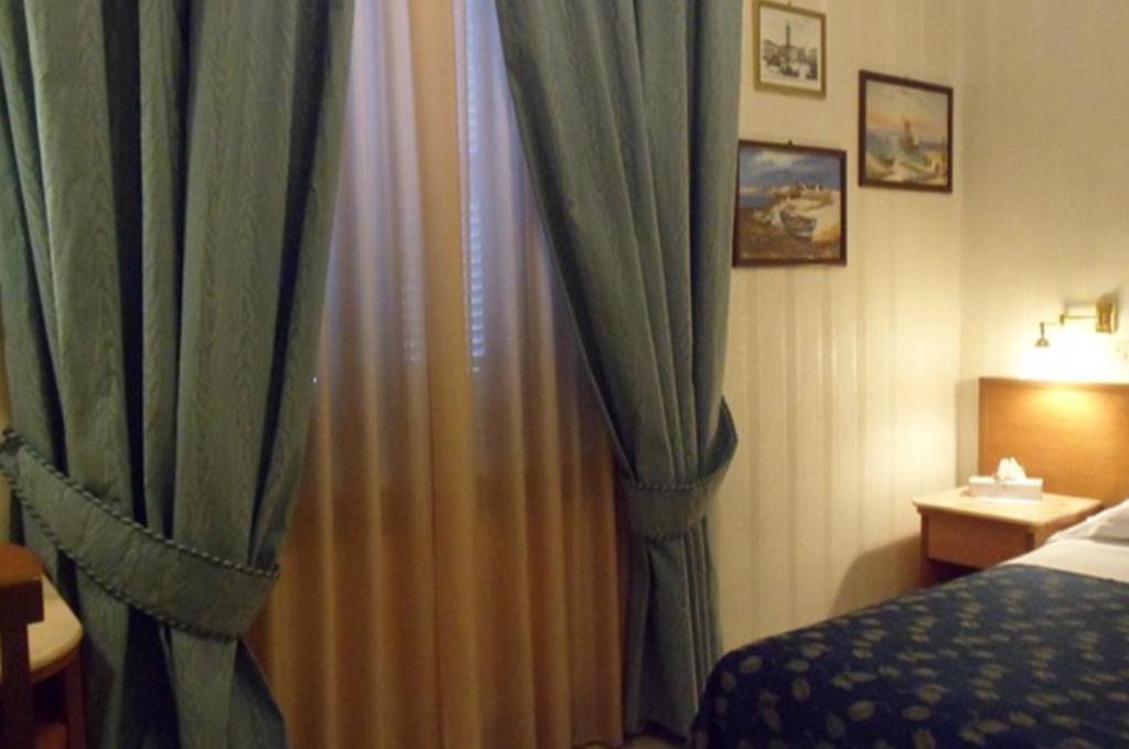 Posteľ alebo postele v izbe v ubytovaní Hotel Alba