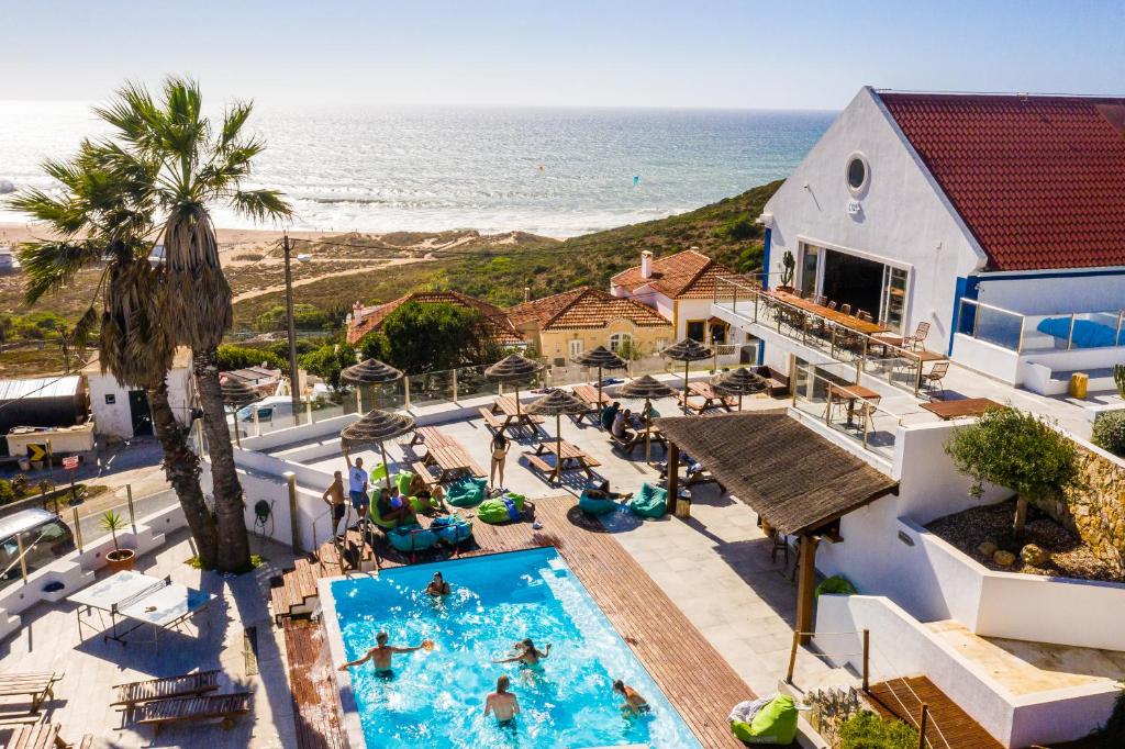 an overhead view of a swimming pool and the ocean at Lapoint Surf Camp Ericeira in Ericeira