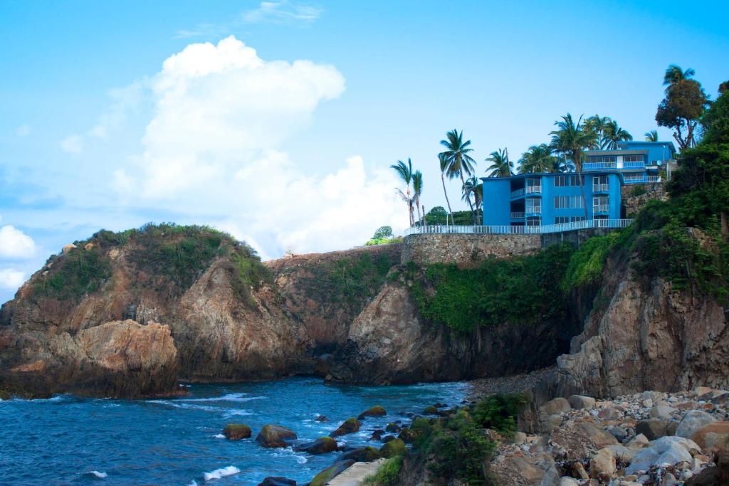 una casa en lo alto de un acantilado junto al agua en Coral Clubes Acapulco, en Acapulco