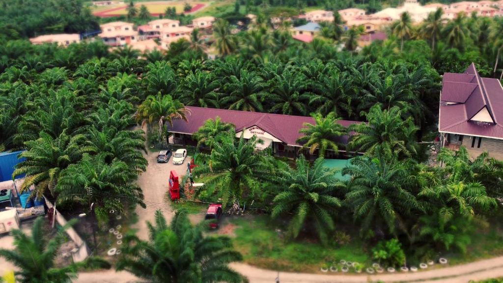 an aerial view of a resort with palm trees at Hemingway Cottage 海明威度假屋 in Semporna